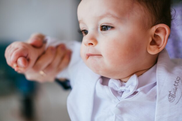 The tenderness boy sitting on the bed