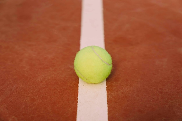 Tennis ball on white line