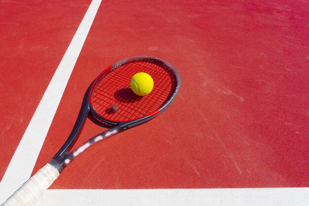 Tennis balls and racket on the grass court