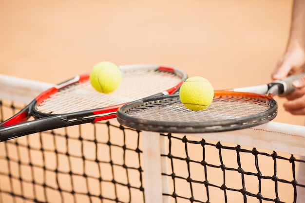 Tennis couple holding tennis rackets 