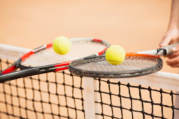 Tennis couple holding tennis rackets 