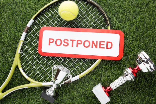 Free photo tennis elements arrangement with postponed sign