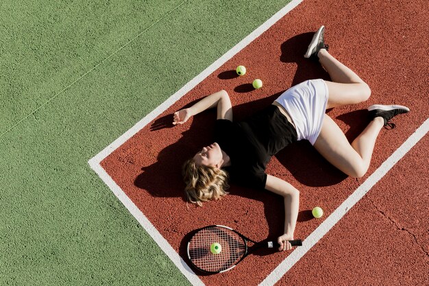 Tennis player on the ground top view