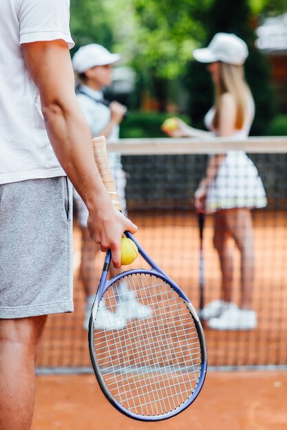 A tennis player man prepares to serve a tennis ball during a match.