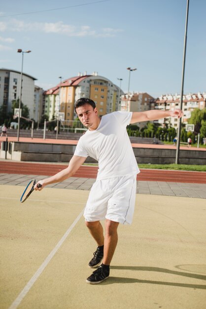 Free photo tennis player striking ball