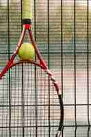 Free photo tennis racket on a fence