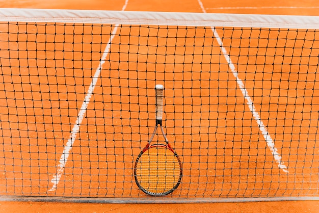 Tennis racket standing on the net