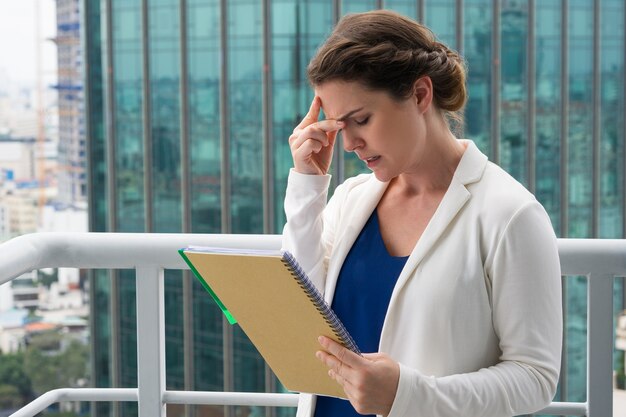 Tense Adult Businesswoman Remembering Idea on Roof