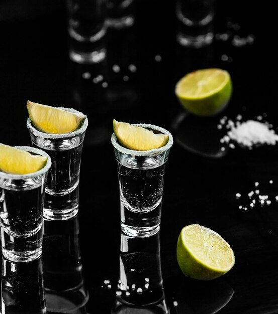 Tequila shots with lemon on the table