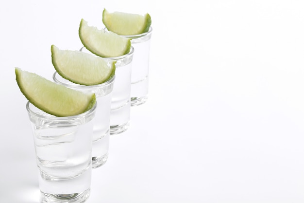 Tequila shots with lime slices