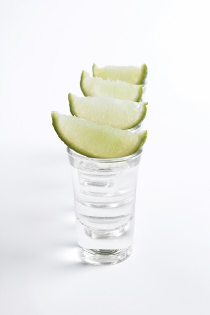 Tequila shots with lime slices