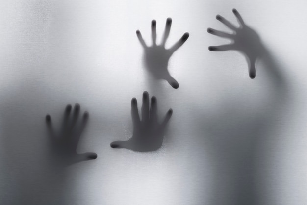 Free photo terrifying hands silhouettes in studio