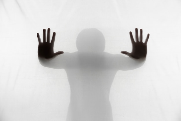 Free photo terrifying hands silhouettes in studio