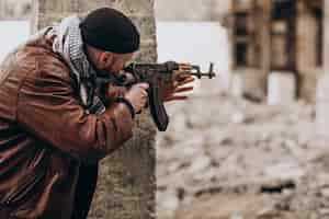 Free photo terrorist with gun fighting with soldiers