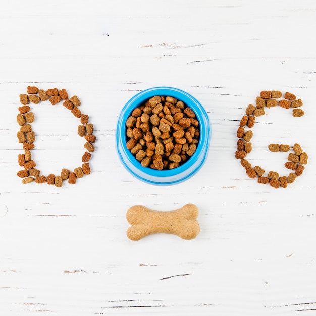 Text dog with bone on white wooden surface