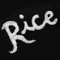 Free photo text written with uncooked rice on black background