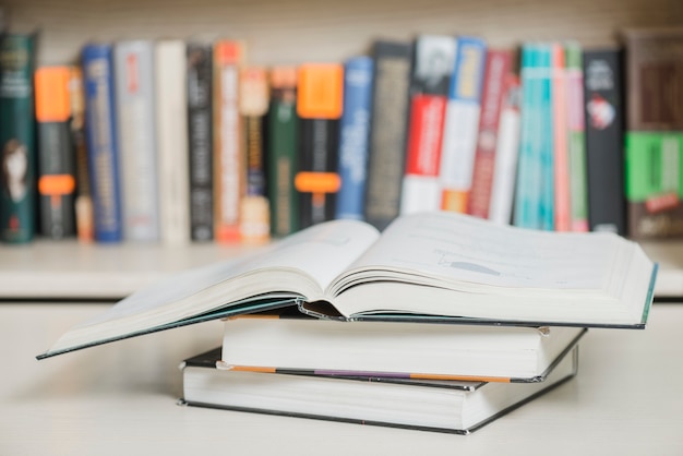 Free photo textbooks lying near bookcase