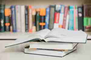 Free photo textbooks lying near bookcase