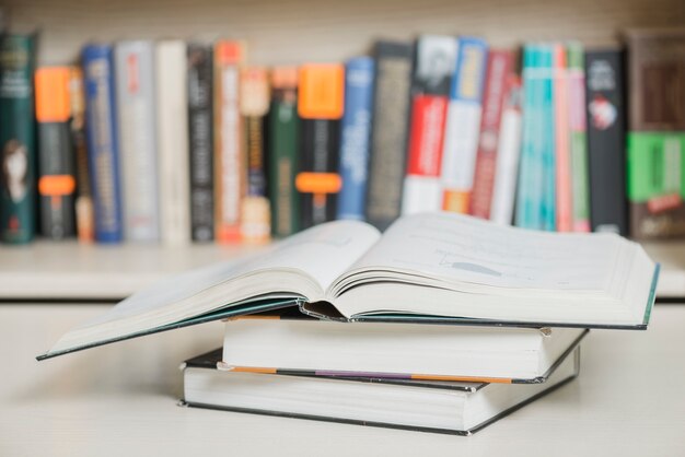 Textbooks lying near bookcase