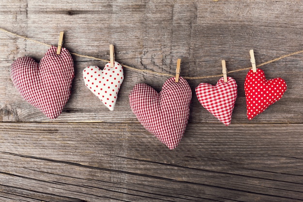 Textile valentines day hearts on wooden