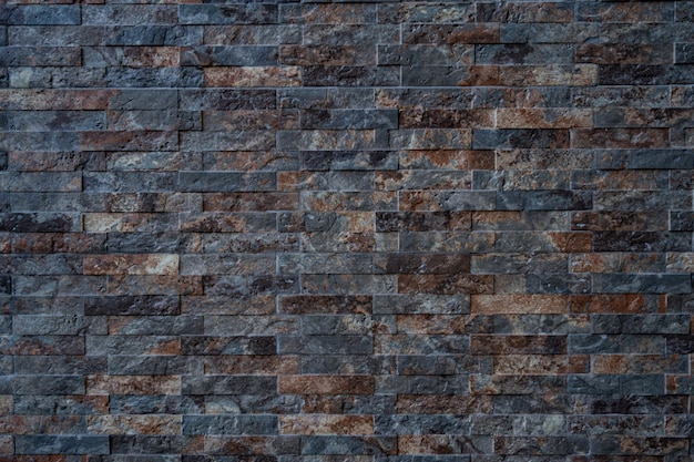 Текстура черного с коричневой кирпичной каменной стеной
