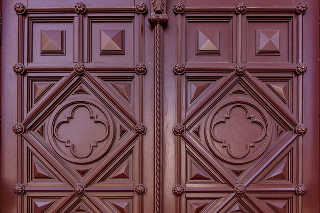 Texture of dark burgundy wood. Texture of old dried plywood. Mahogany background for design.