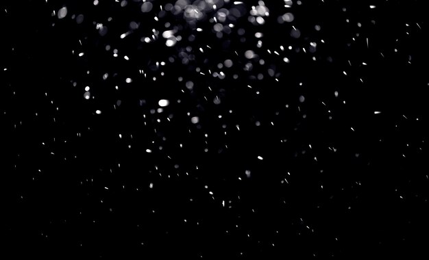 Texture of falling snow layer to overlay on a black background