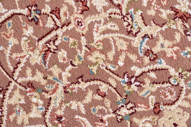 Texture of intricate floral pattern of short pile rug