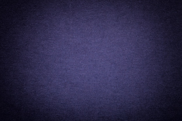 Texture of old navy blue paper background, closeup