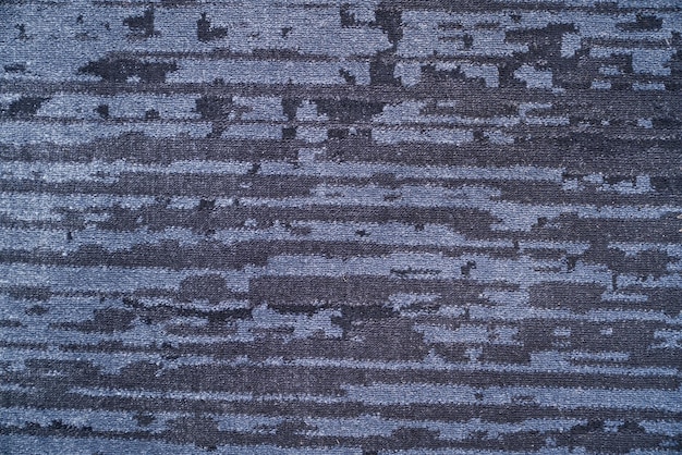 Texture of saturated striped dark grey velvet rug surface