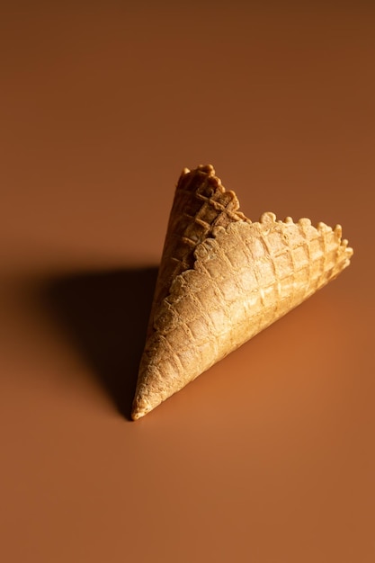 Free photo textured waffle cone on a brown background isolated close up