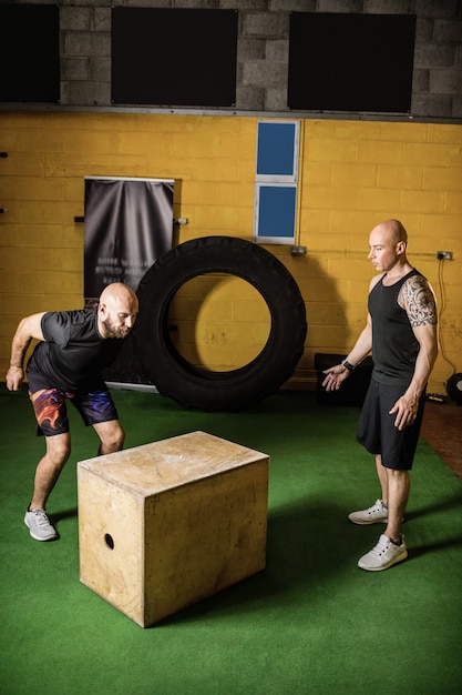 Free photo thai boxers practicing on wooden box