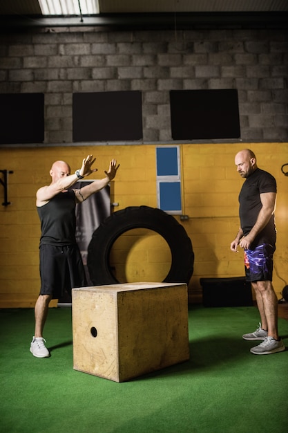 Free photo thai boxers practicing on wooden box