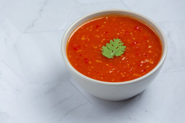 Thai sukiyaki spicy sauce in white tiny bowl