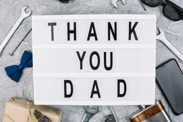 Thank you dad inscription on tablet between male accessories