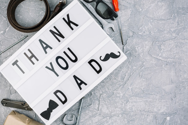 Thank you dad inscription on tablet near male accessories