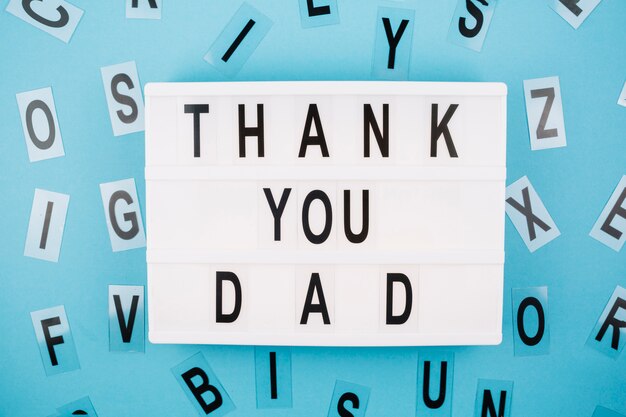 Thank you dad title on tablet near letters