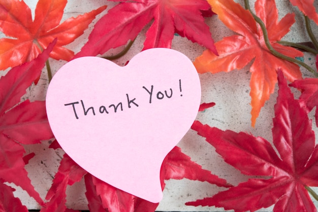 Thank you note in heart shape paper with maple leaf