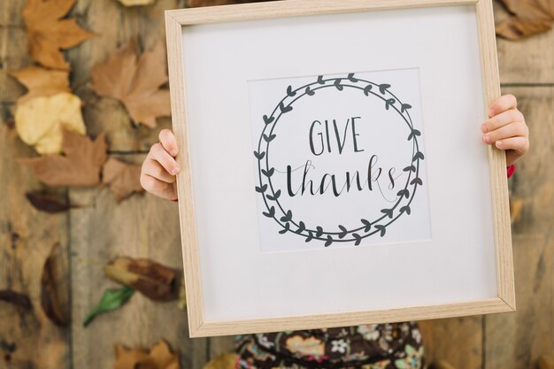 Thanksgiving concept with kid holding frame