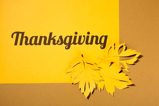 Thanksgiving lettering with leaflets on table