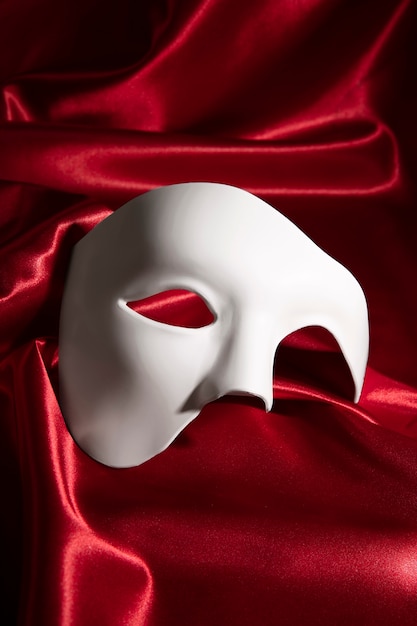 Theater mask on red curtain