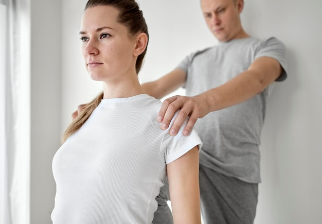 Therapist undergoing physical therapy with female patient