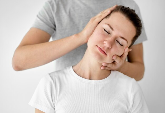 Therapist undergoing physical therapy with female patient