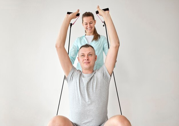 therapist undergoing physical therapy with male patient