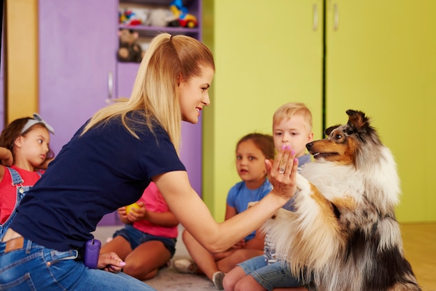 Therapy dog giving woman the paw