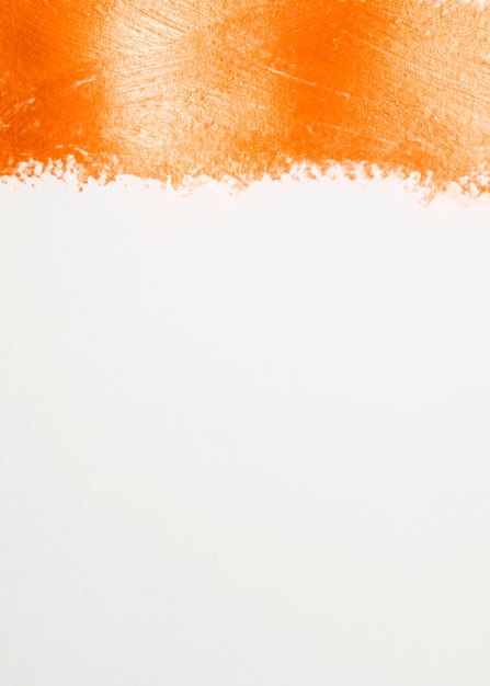 Thick line of orange paint and white background