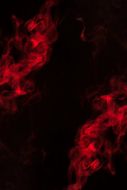 A thick twirling smoke pattern on the corner of black background