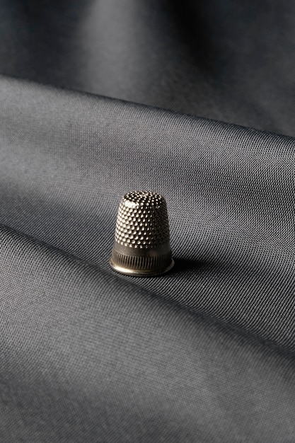 Free photo thimble on silk high angle