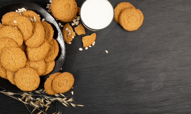 Thin oatmeal cookies or healthy cereal oat crackers top view. crispy anzac biscuit cookie with oat flakes on rustic table background
