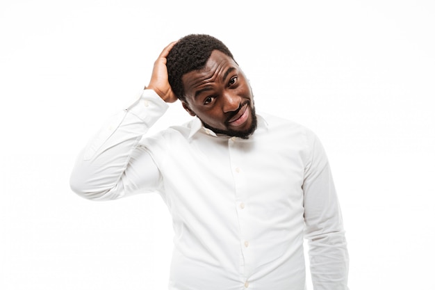 Thinkful young man dressed in shirt standing and posing